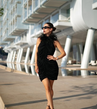 Black draped dress with feathers